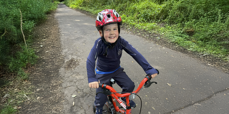 Child with helmet on bike