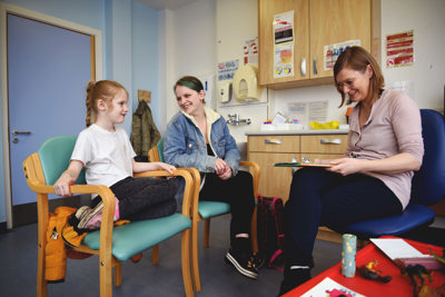 A doctor with a child and their mother