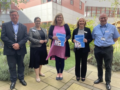 Attendees at the launch of the National Spiritual Care Framework pose with a copy of the document