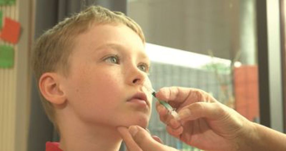 Child receiving nasal spray vaccination