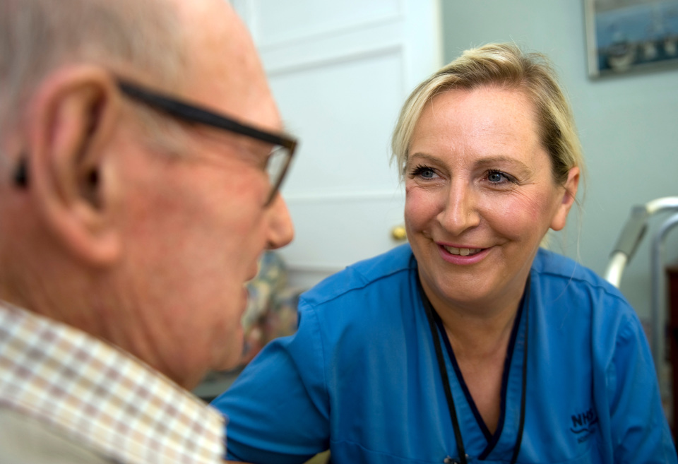 Nurse talking to older patient
