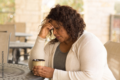 woman leaning on hand in distress