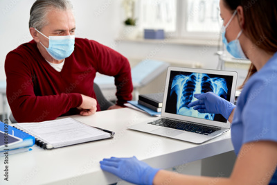 doctor and patient looking at chest scan