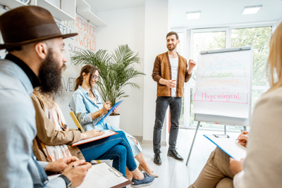 man standing presenting to group