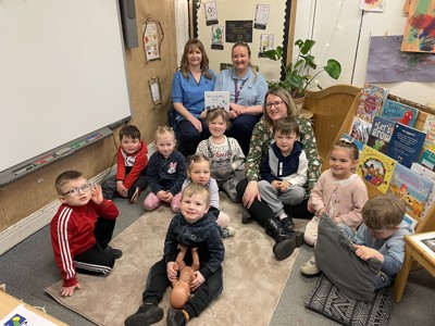 Children in nursery posing with staff from NHS Fife's dental public health service