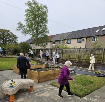 Local residents enjoying the new community garden at St Margaret's Church, Glenrothes, funded by Fife Health Charity via NHS Charities Together Partnership Grants Programme.