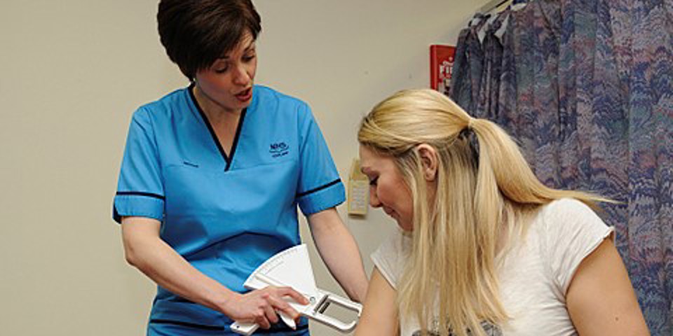 Nurse measuring patients BMI