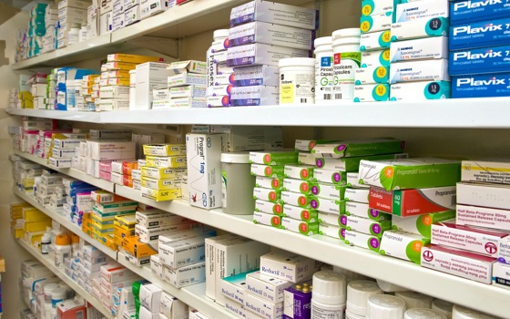 Pharmacy shelves filled with medicine boxes